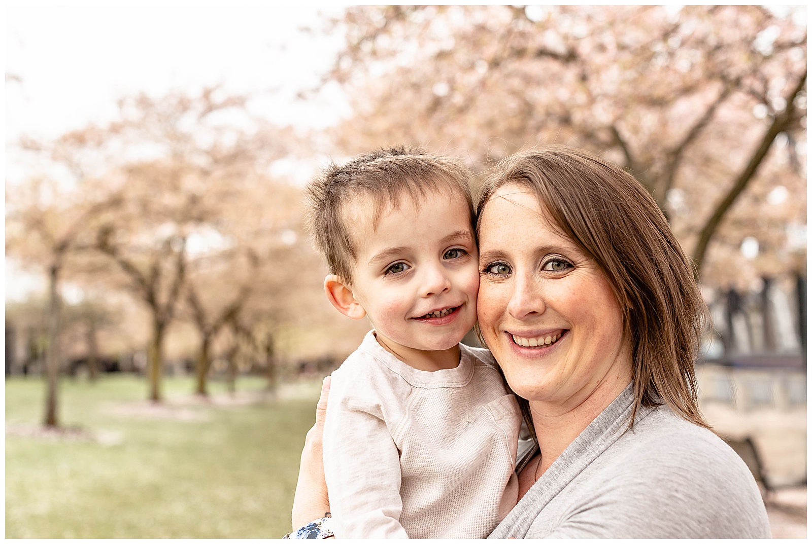 Mother and Son in front of cherry blossom trees