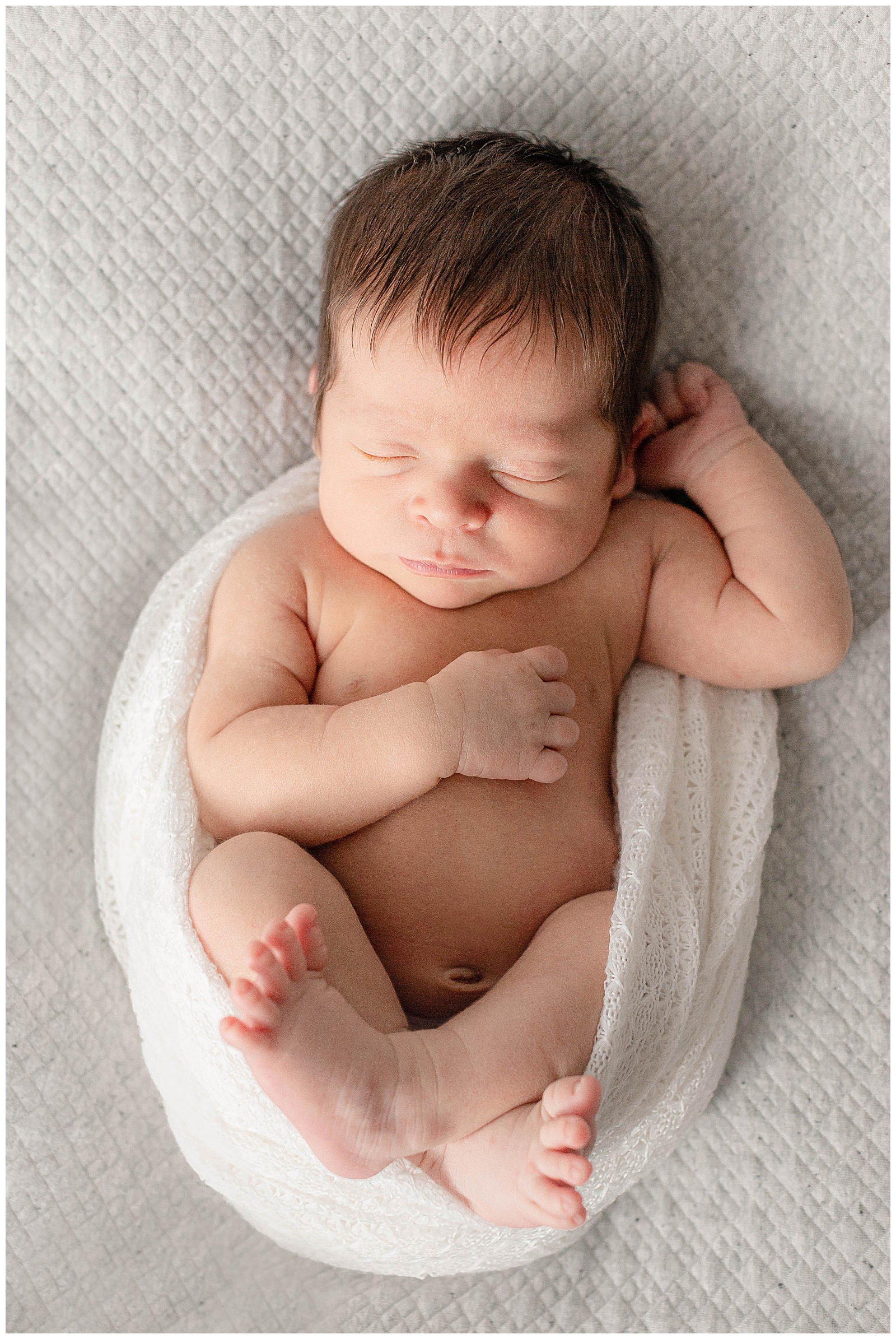 Newborn posed photograph with grey background