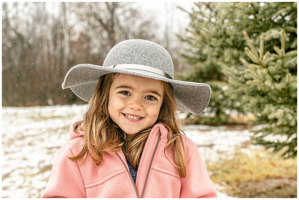 4 year old girl in grey hat snowy background