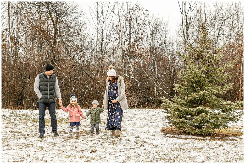 Family of 4 walking through the snow