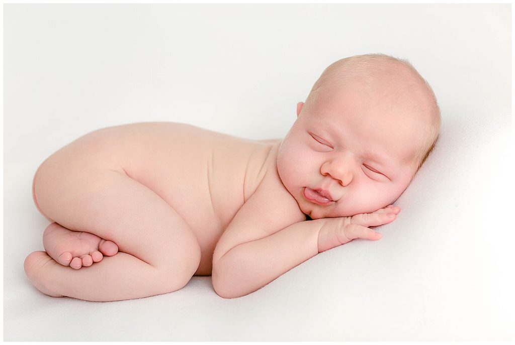 Baby sleeping on belly for newborn photos
