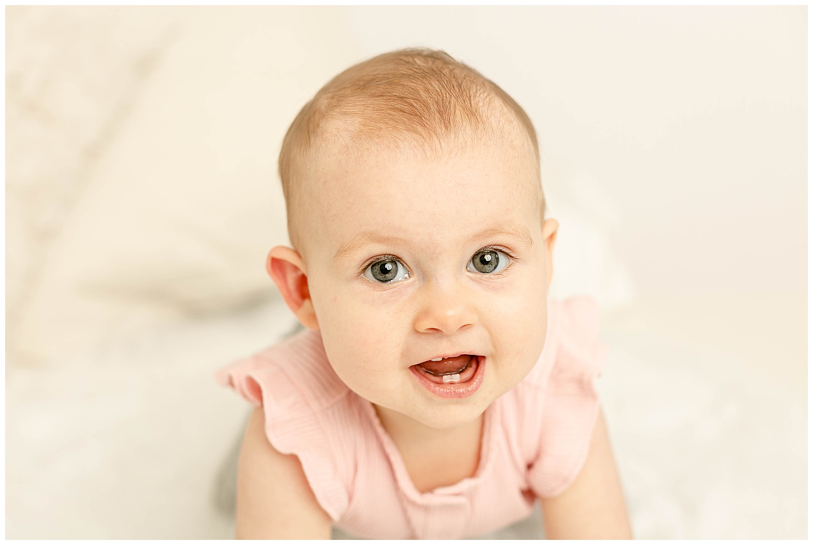 Baby crawing towards camera during milestone photo session