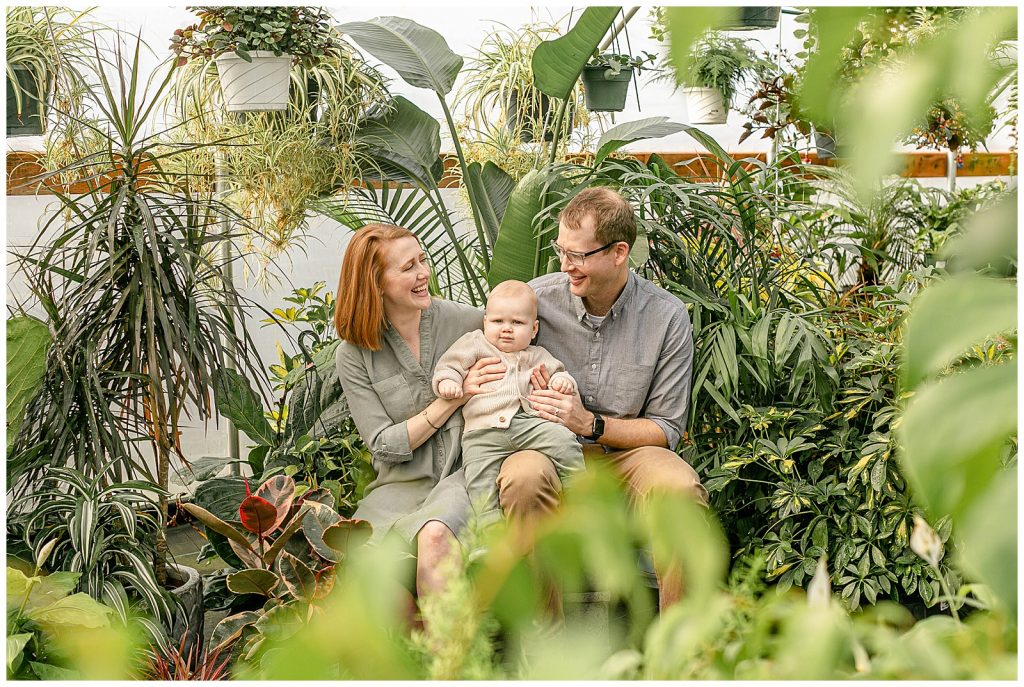 Nine month milestone family photo session at Tony's Garden Center in indoor plant greenhouse