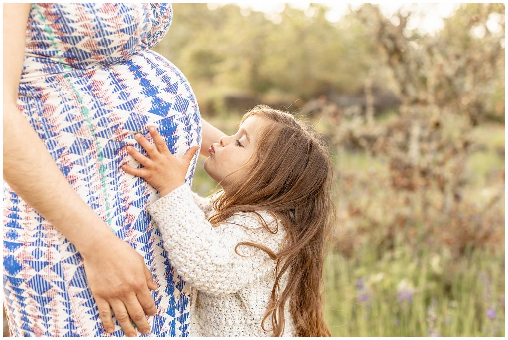 Maternity photos with big sister at Nature park with blue wildflowers