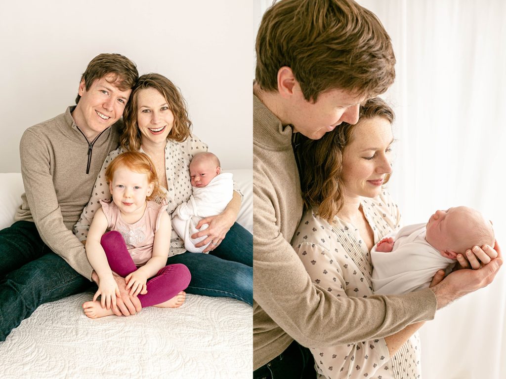 Family of four with new baby all smiling at the camera