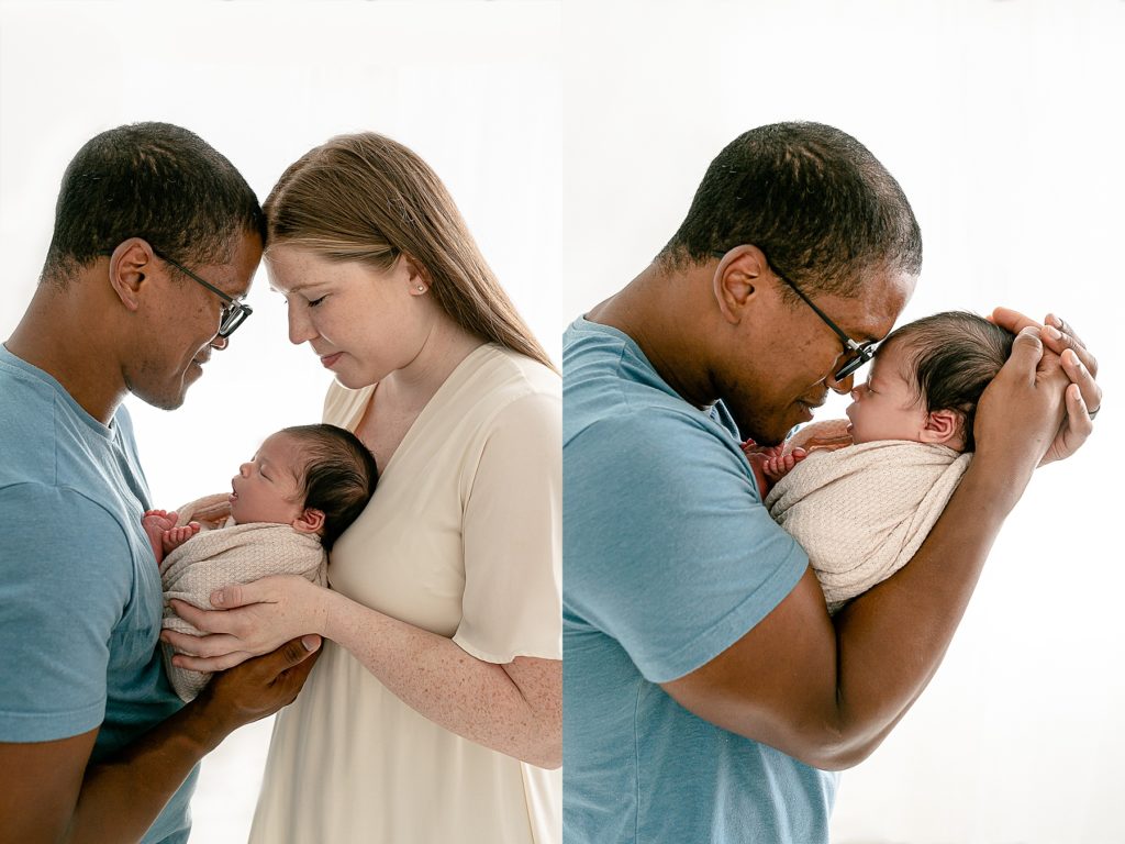 Mixed race couple holding new baby during photo session at a Portland Oregon Photography studio