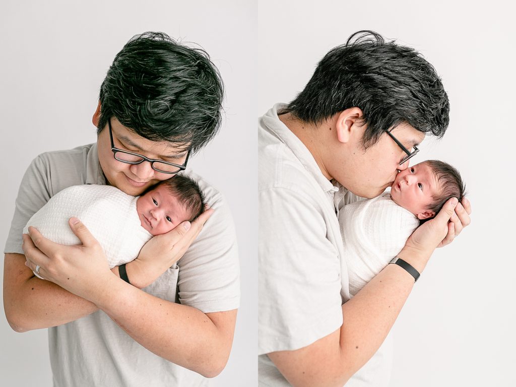 Asian dad holding newborn baby in light and airy newborn photography session