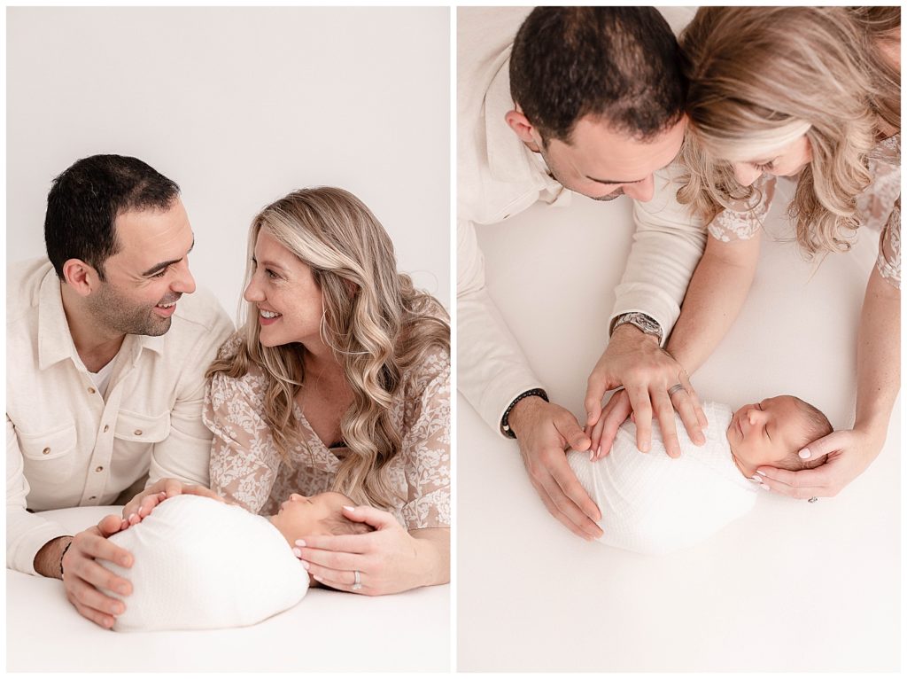 Mom and Dad holding their baby on a white background. Family dressed in neutral tones and colors at their Portland Newborn Photography Session.