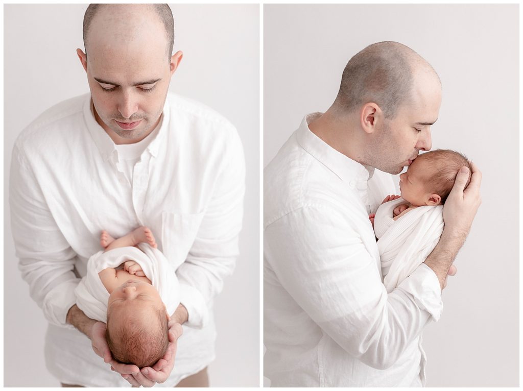 Light-skinned man in white button-up shirt & Khaki pants holding newborn baby in white swaddle. Left photo is shot straight on with dad holding baby at chest with head in his hands and he is looking down at baby. Right photo is shot from the side with dad holding baby at chest and head in his hands and he is kissing the top of baby's head. 
