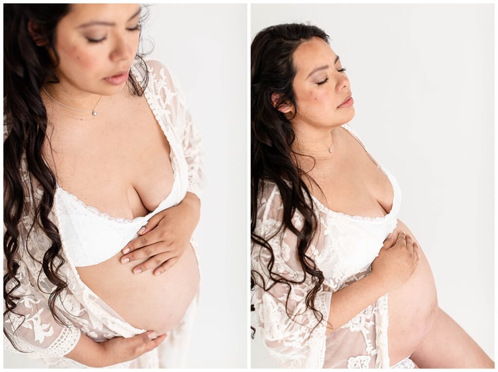 Intimate maternity portraits with a mom with dark, long, curly hair and dressed in white intimates with a lace robe over top.