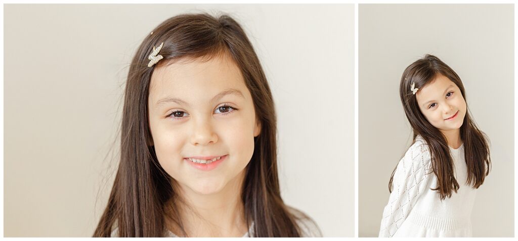 young girl in white dress smiling at the camera.