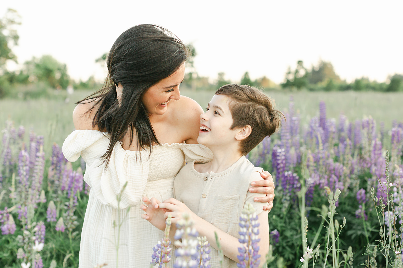 A happy young boy explores and laughs with mom in a lavender farm after some Mamaspace Yoga