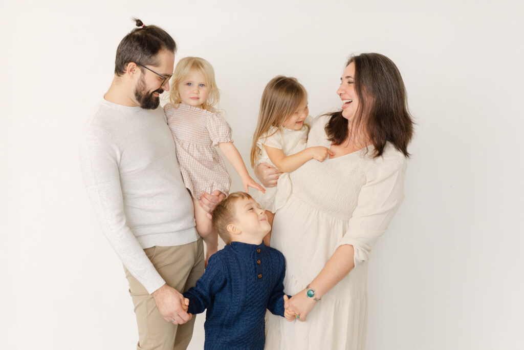 Family milestone portraits in Portland OR showing genuine connection between parents and children