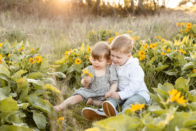Photographer gently guiding a family during a candid Portland portrait session