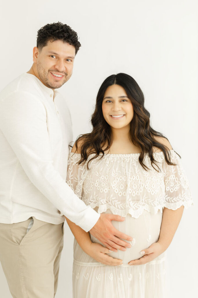 Pregnant mother and partner sharing a tender moment during a maternity session
