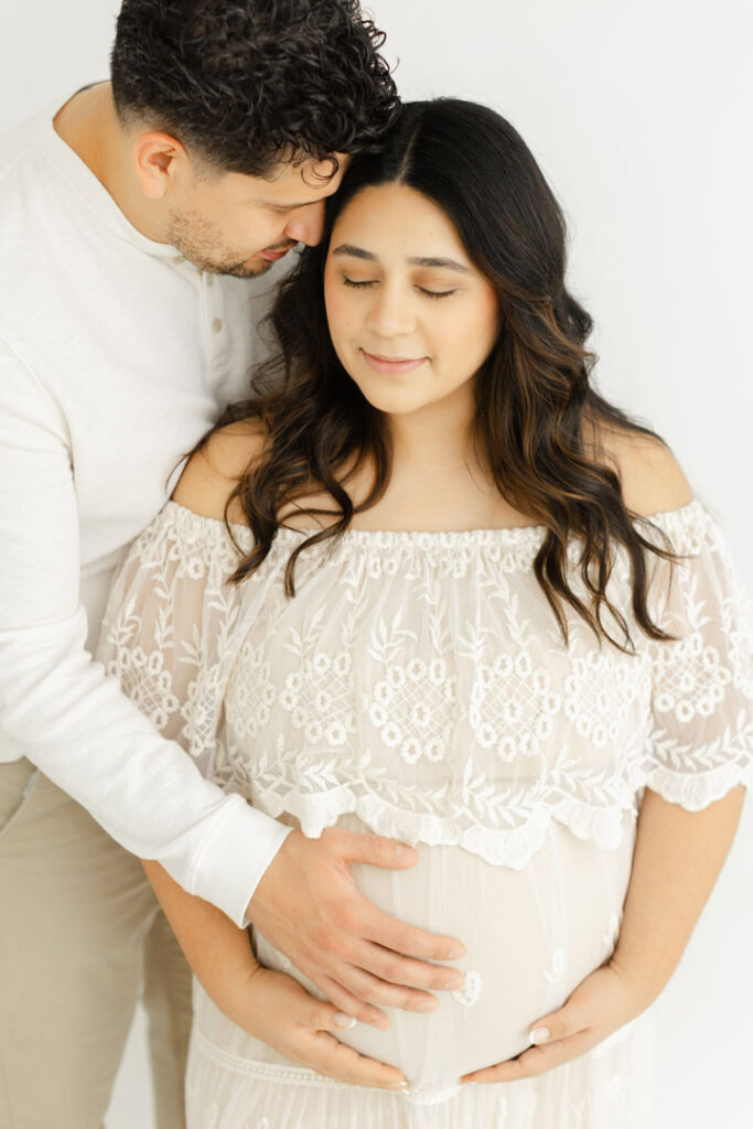 Expecting couple embracing during an intimate Portland maternity photography session